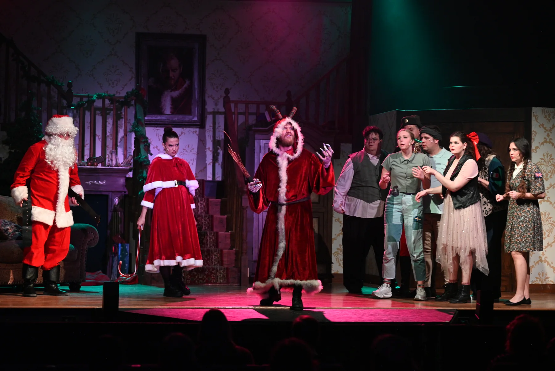 Krampus, Santa and the ensemble on the festive stage in the 2025 production.