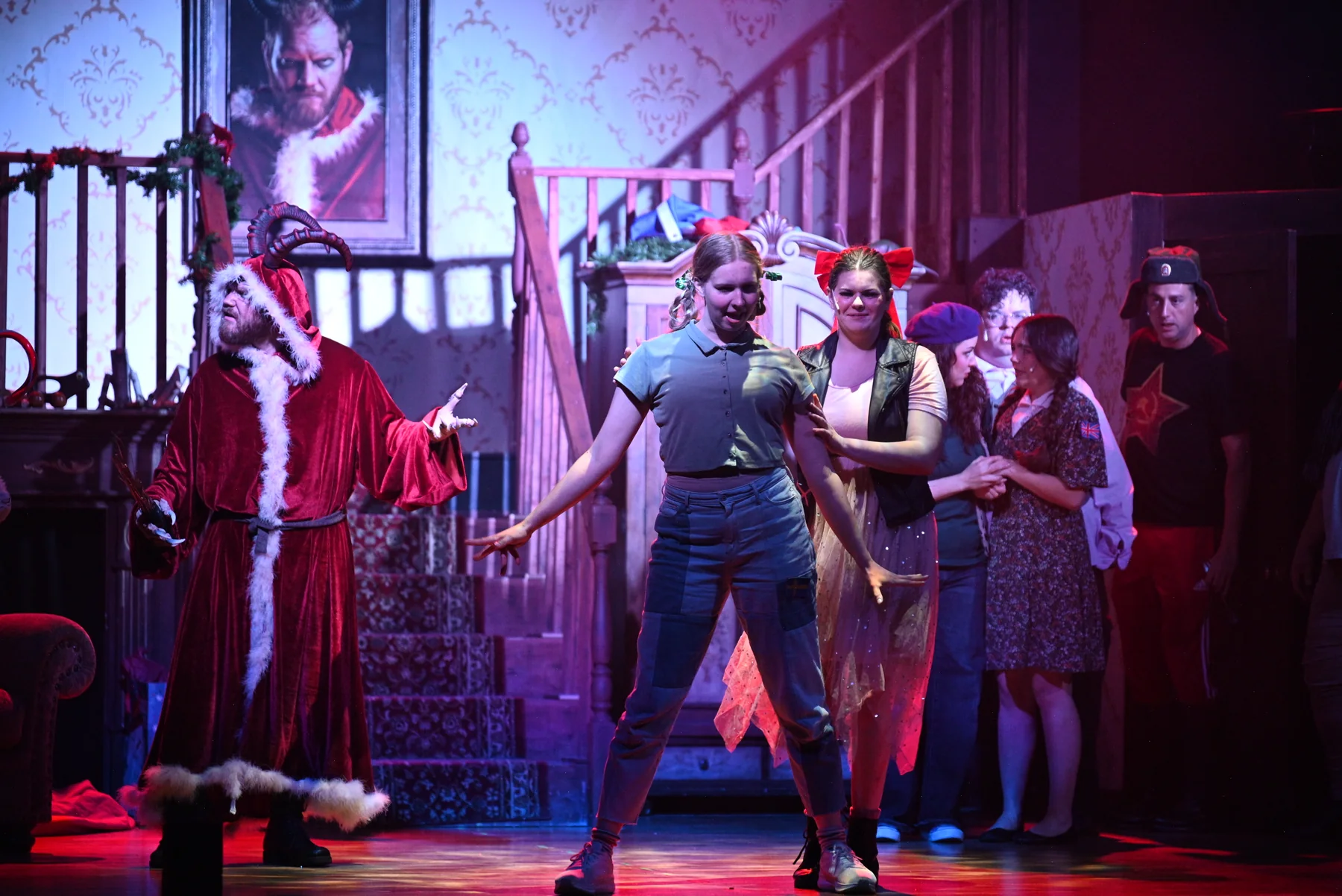 Krampus confronts the children beside the staircase in the 2025 production.